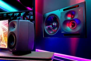 Vibrantly lit audio studio with sleek speakers. Neon hues of purple, pink, and blue highlight a modern ambiance, conveying creativity and energy.